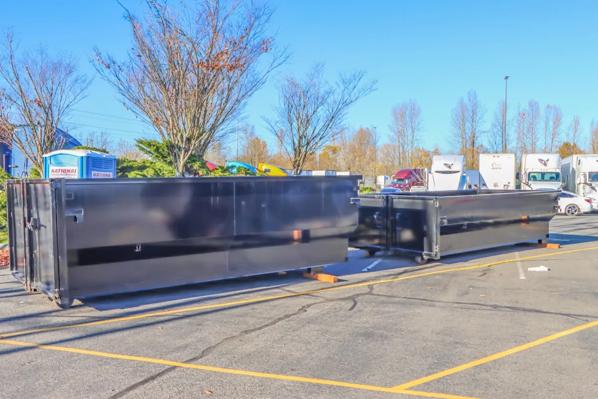 Professional dumpster rental service with roll-off container on residential driveway in Waterboro